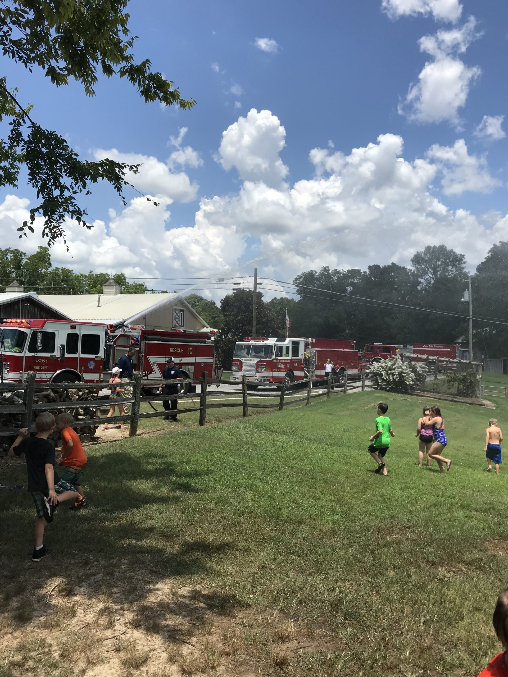 Campers enjoying field day with water slide and fun